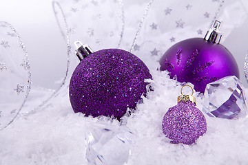 Image showing beautiful christmas decoration in purple and silver on white snow