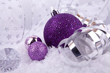 Image showing beautiful christmas decoration in purple and silver on white snow