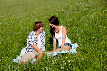 Image showing young couple outdoor in summer on blanket in love