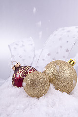 Image showing beautiful gold and red christmas decoration on white snow