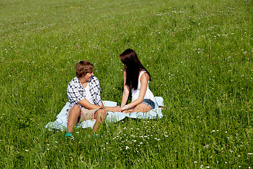 Image showing young couple outdoor in summer on blanket in love