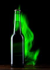 Image showing Beer bottle with color fire