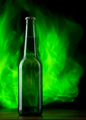 Image showing Beer bottle with color fire