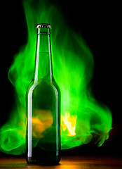 Image showing Beer bottle with color fire