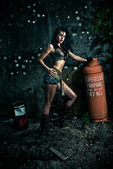 Image showing Macho woman posing with gas bottle