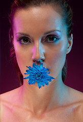 Image showing Beautiful woman with flower in mouth