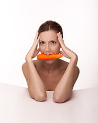 Image showing Sexy brunette with a carrot