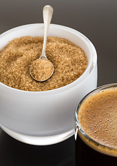 Image showing Black coffee and froth in glass mug with sugar