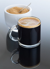 Image showing Black coffee and froth in glass mug with sugar