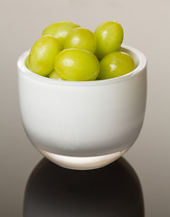 Image showing White glass bowl full of green grapes