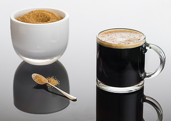 Image showing Black coffee and froth in glass mug with sugar