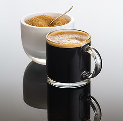Image showing Black coffee and froth in glass mug with sugar