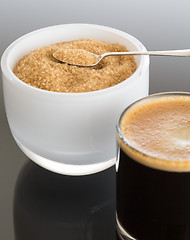 Image showing Black coffee and froth in glass mug with sugar