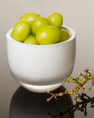 Image showing White glass bowl full of green grapes