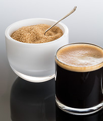 Image showing Black coffee and froth in glass mug with sugar