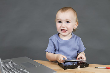 Image showing child working at open hard drive