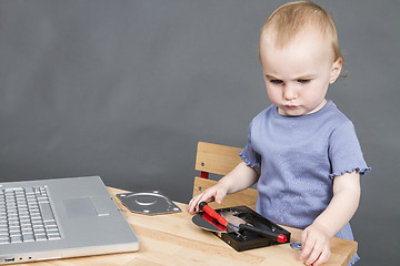 Image showing child working at open hard drive