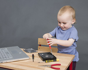 Image showing child working at open hard drive