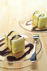 Image showing fresh cream cake closeup with chocolate sauce