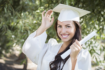 Image showing Graduating Mixed Race Girl In Cap and Gown with Diploma