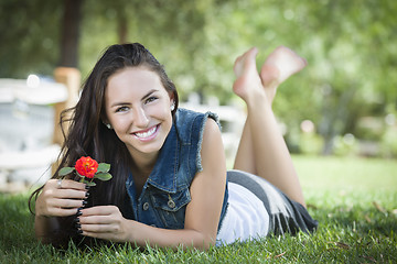 Image showing Attractive Mixed Race Girl Portrait Laying in Grass