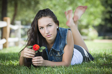 Image showing Attractive Mixed Race Girl Portrait Laying in Grass