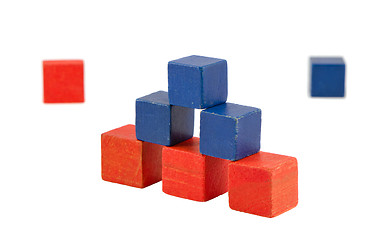 Image showing Pyramid made of wooden red blue color toy bricks 