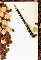 Image showing Coffee beans, paper, pen