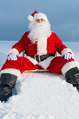 Image showing Santa sitting on sunbed in snow