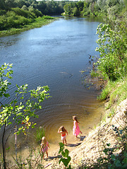 Image showing Three little girls plays at the river