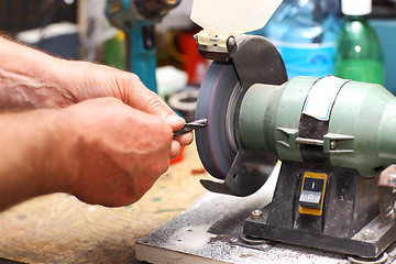 Image showing Man working with sharpening machine tool