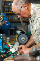 Image showing Senior working in workshop