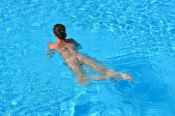 Image showing Young woman swiming in the blue sea