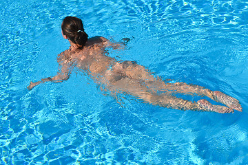 Image showing Young woman swiming in the sea