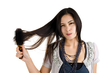 Image showing woman brushing her hair