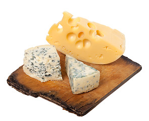 Image showing Various types of cheese on old wooden kitchen board