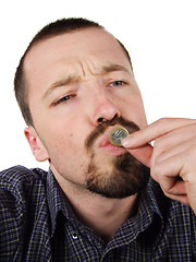 Image showing Young male kissing a 1 Euro coin