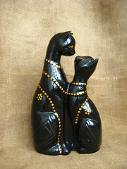 Image showing Two toy enamoured cats on a brown background