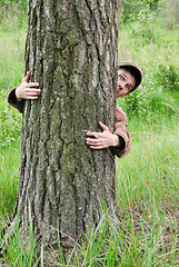 Image showing Man hugging tree