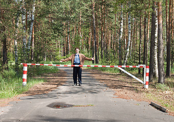 Image showing Young man behind a barrier