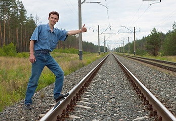 Image showing Man on railway with the lifted hand