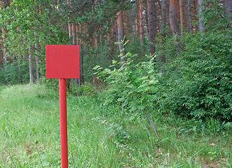 Image showing Red metal plate in wood