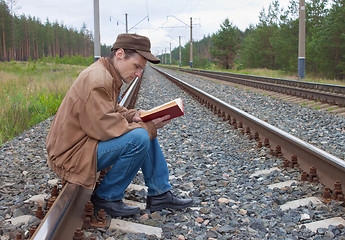 Image showing Man sits on railway and with reads 