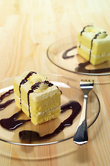 Image showing fresh cream cake closeup with chocolate sauce