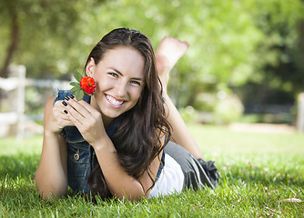 Image showing Attractive Mixed Race Girl Portrait Laying in Grass