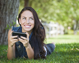 Image showing Mixed Race Young Female Texting on Cell Phone Outside