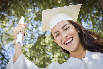 Image showing Graduating Mixed Race Girl In Cap and Gown with Diploma