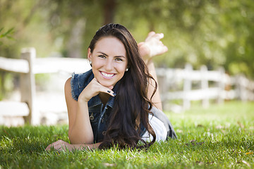Image showing Attractive Mixed Race Girl Portrait Laying in Grass