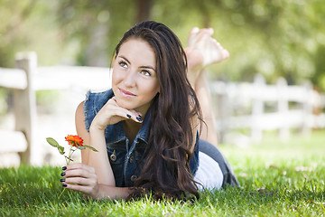 Image showing Attractive Mixed Race Girl Portrait Laying in Grass