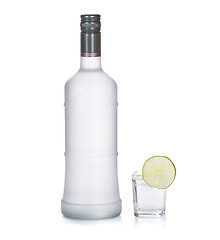 Image showing bottle of vodka with lime isolated on white